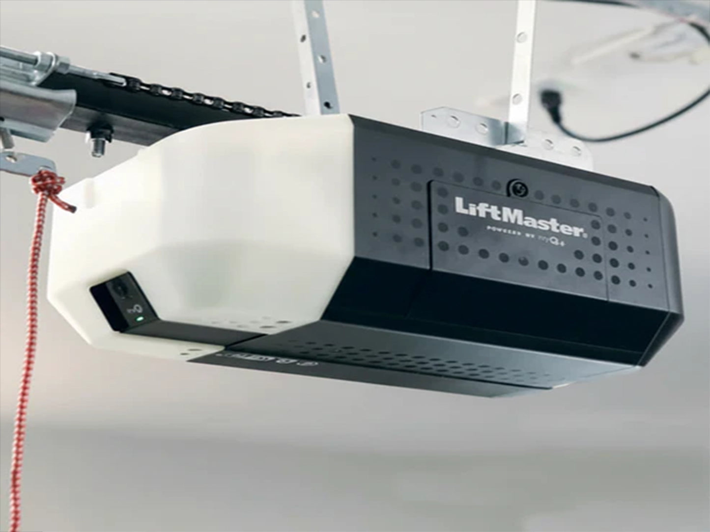 LiftMaster 2420L chain-drive garage door opener mounted to a ceiling, featuring a black and white head unit with an integrated camera. Thumbnails display the included 3-button remote (993S) and wireless keypad (L979S) next to a base price of $423.92.