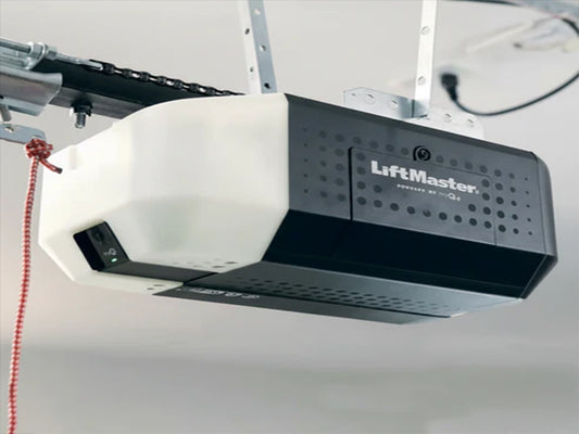 LiftMaster 2420L chain-drive garage door opener mounted to a ceiling, featuring a black and white head unit with an integrated camera. Thumbnails display the included 3-button remote (993S) and wireless keypad (L979S) next to a base price of $423.92.